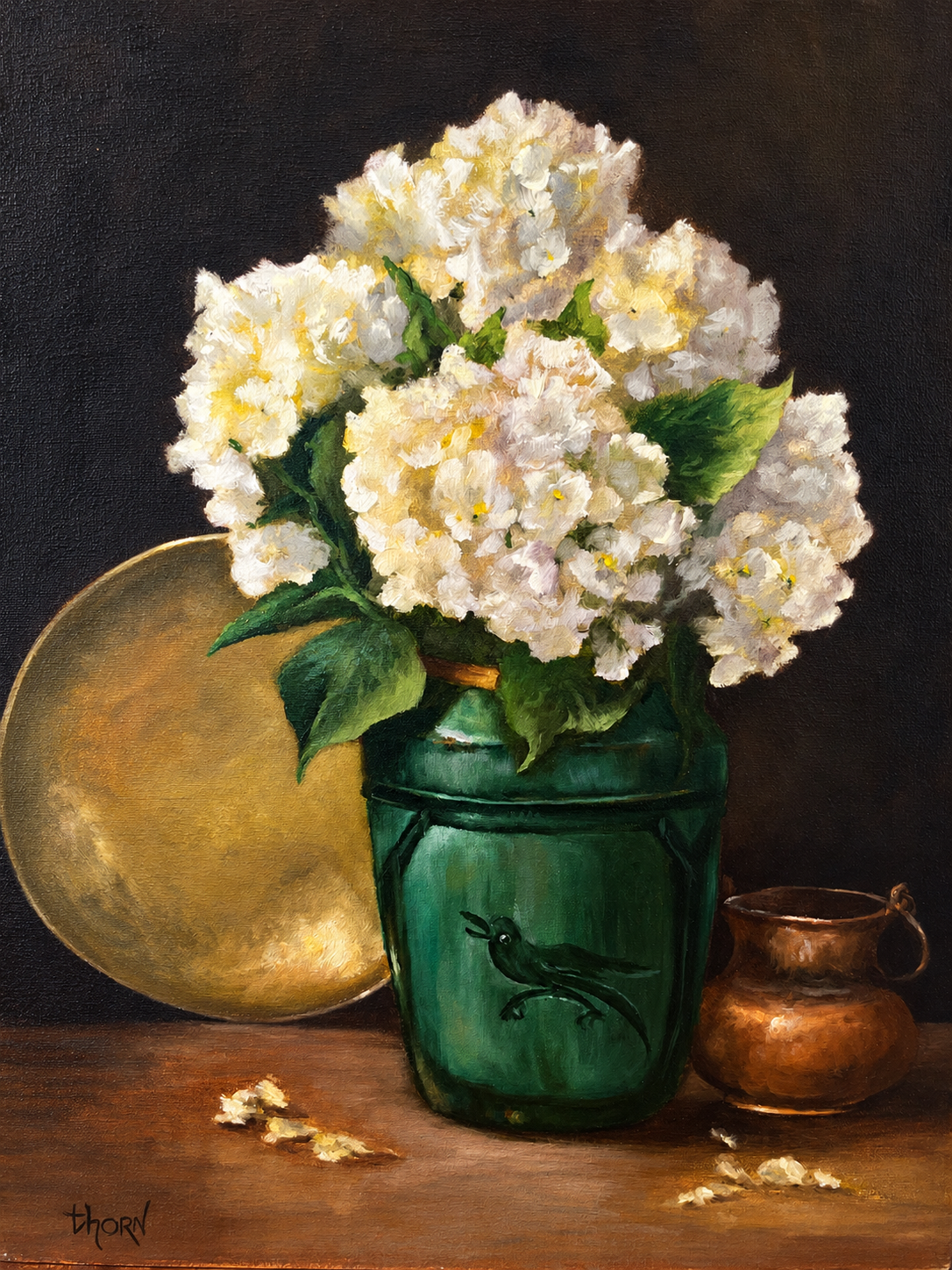 Pale flowers arranged in a green jar