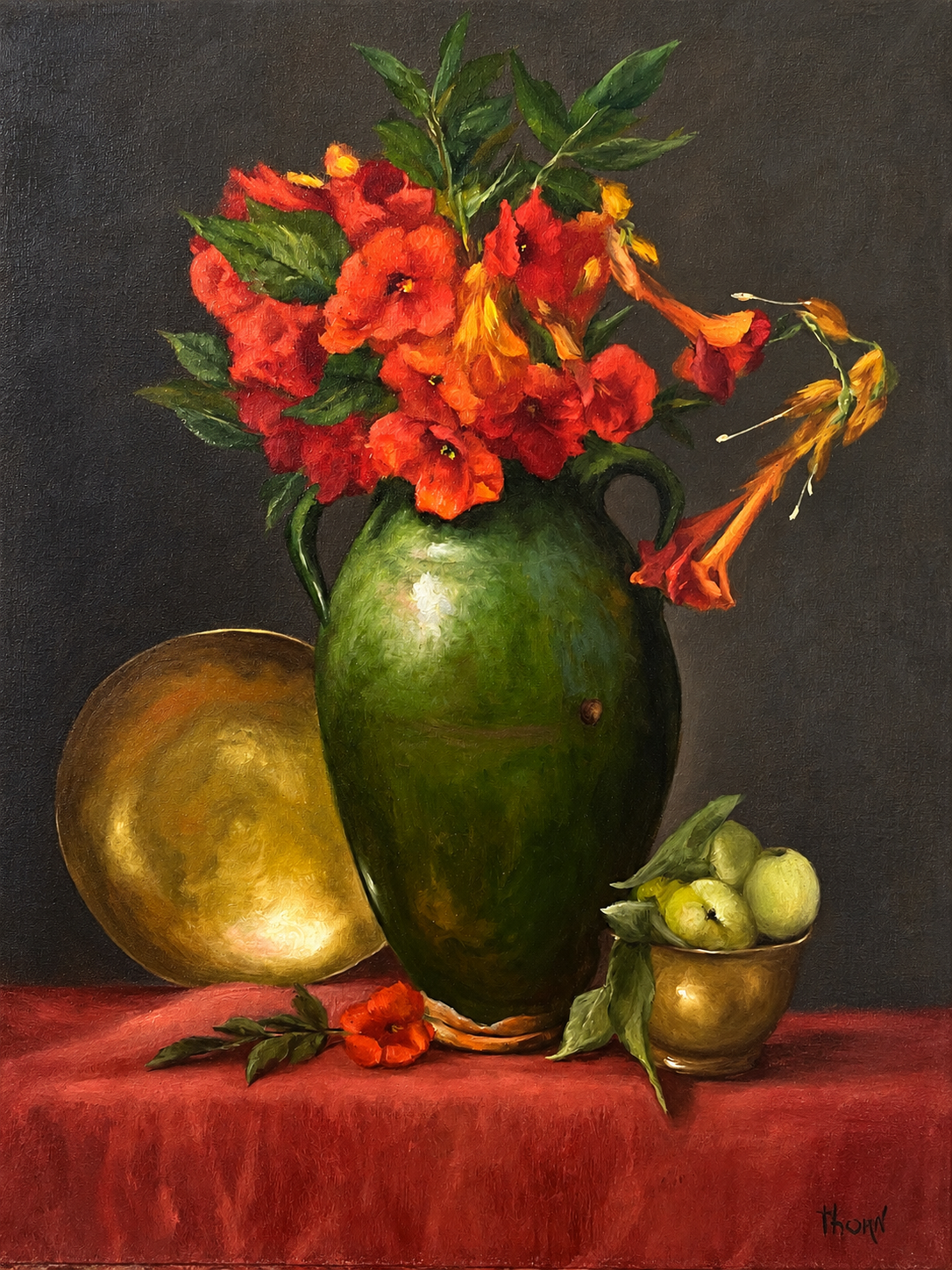 Red flowers in a green vase with fruit, a small bowl and red cloth